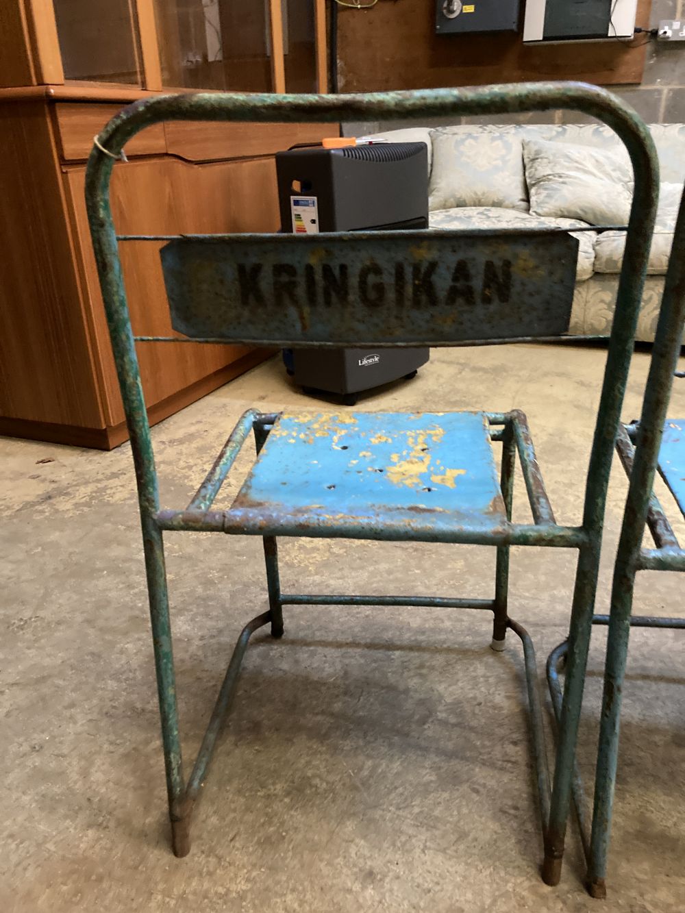 Four painted metal stacking chairs